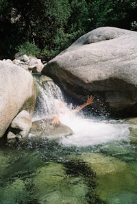 a person riding a surfboard in a waterfall