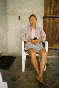 a man sitting on a white chair