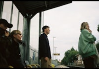 a group of people standing on a train platform