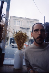 a man sitting in front of a window