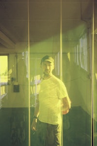 a man standing in front of a glass wall