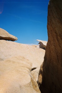 a person is flying a kite in a rock formation