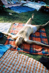 a man laying on a blanket