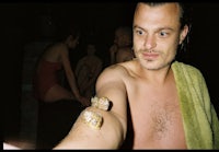 a man in a towel taking a picture of himself