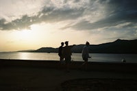 a person is flying a kite near a body of water