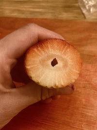 a person holding an apple with a hole in it