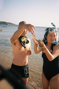 a man and a woman scuba diving in the ocean