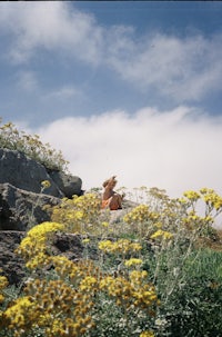 a person sitting on top of a rocky hill