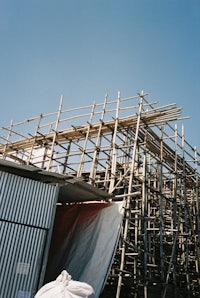 a building with scaffolding and a tarp