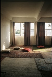 a room with a lot of pillows and rugs