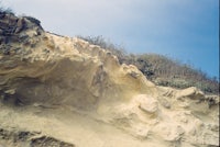 a cliff with a blue sky