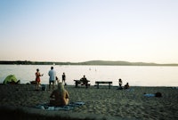 a group of people sitting on a beach