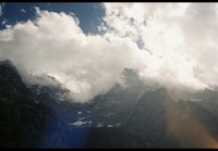 a mountain with clouds in the sky