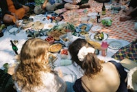 a group of people sitting around a picnic table