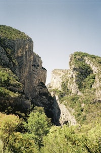 a person riding a horse near a rocky cliff