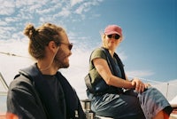 a man and woman sitting on a sailboat